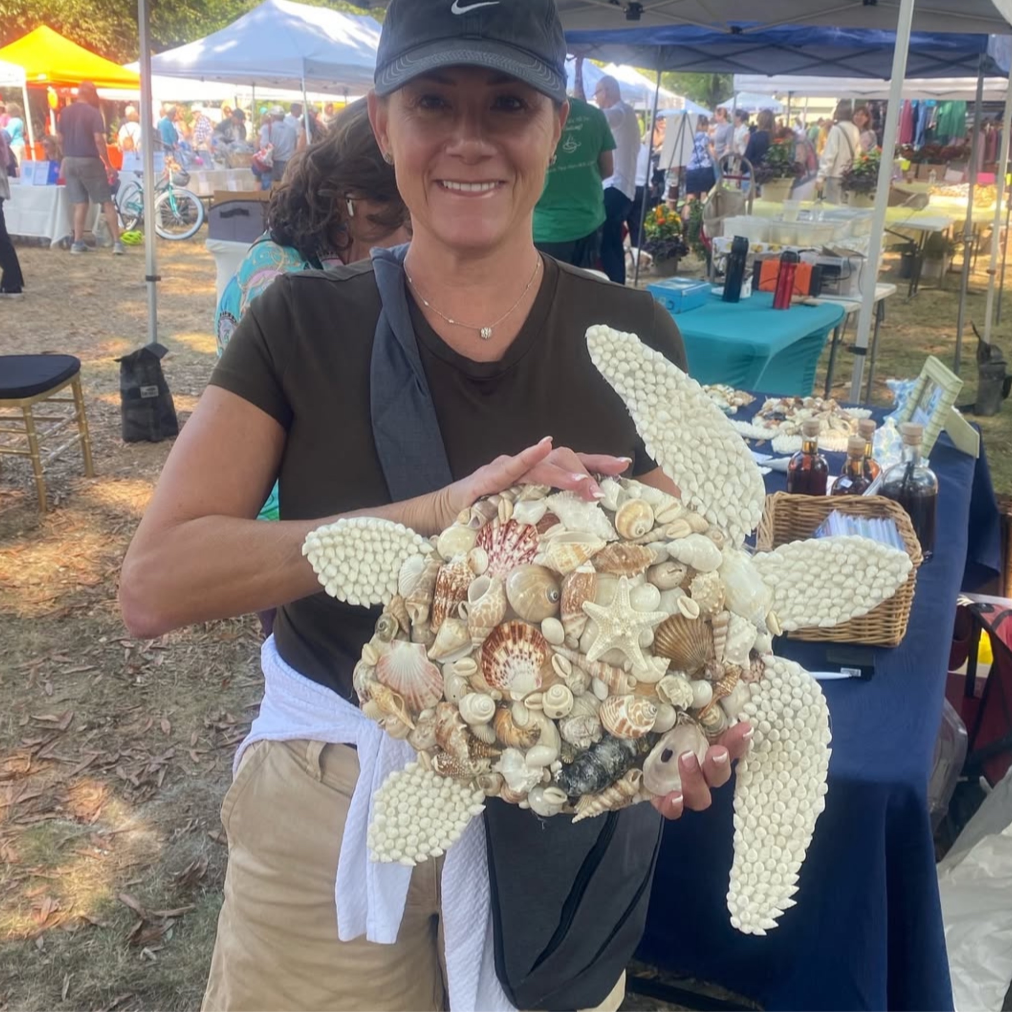 Customer with white shell starfish at outdoor market