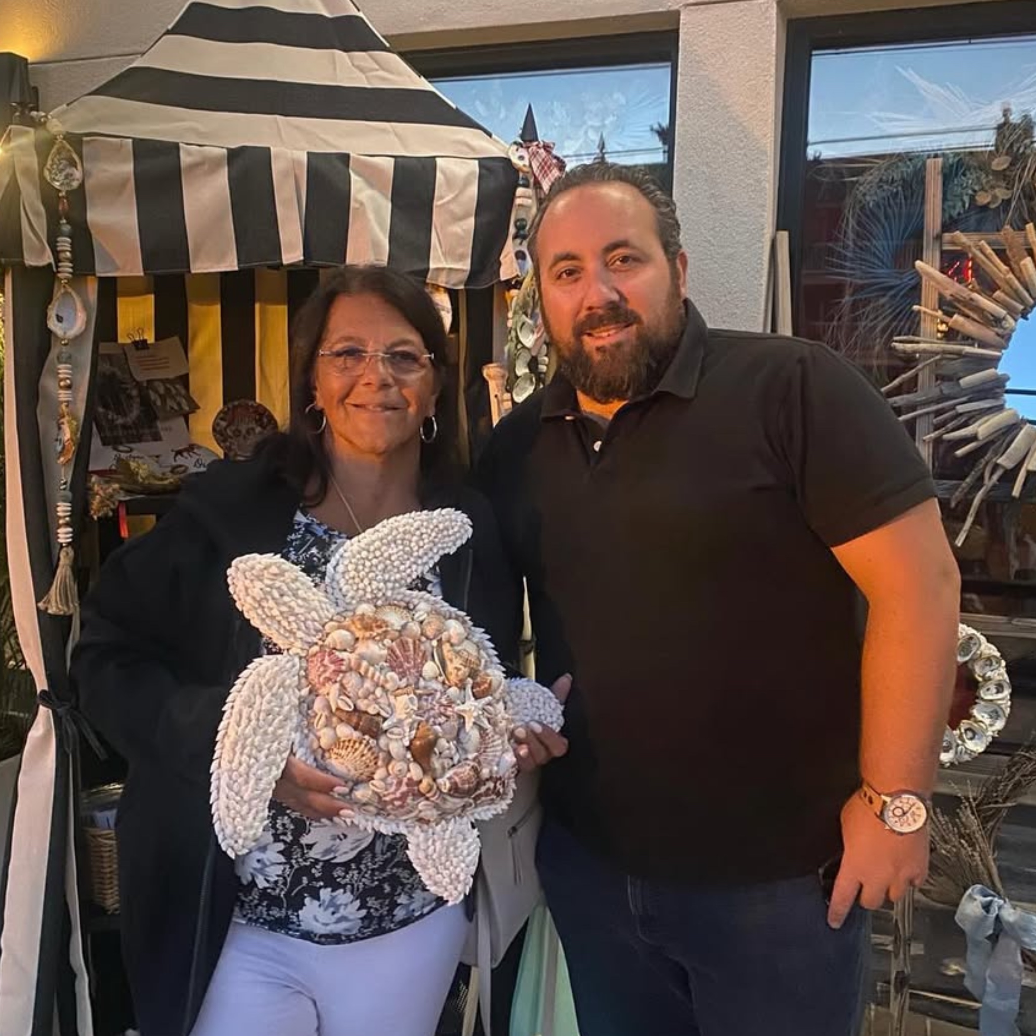 Customer with shell starfish at market booth